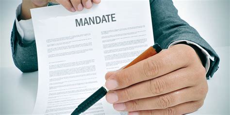 Mandating definition - MANDATING definition: 1. present participle of mandate 2. to give official permission for something to happen: 3. to…. Learn more.